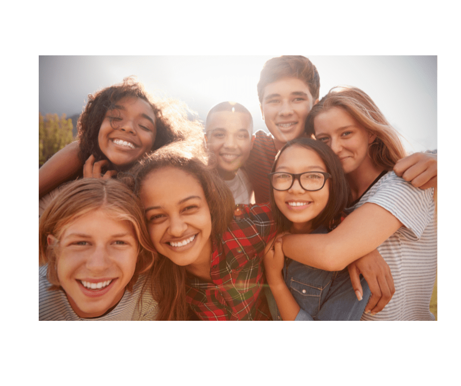 adolescents A group of people that are smiling for the camera.